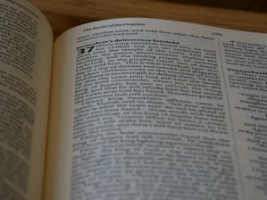 A close-up of an open Bible with soft morning light illuminating the pages