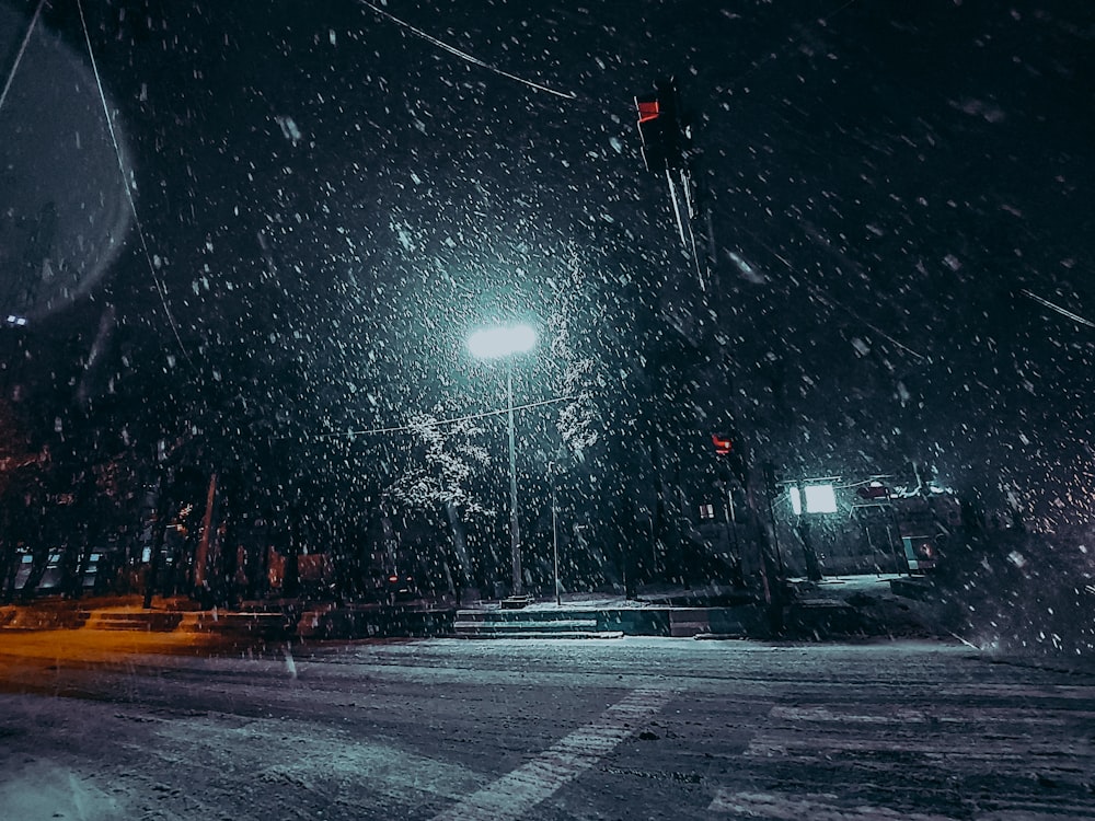 a city street at night covered in snow