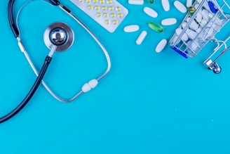 a stethoscope, pills, and a shopping cart on a blue background