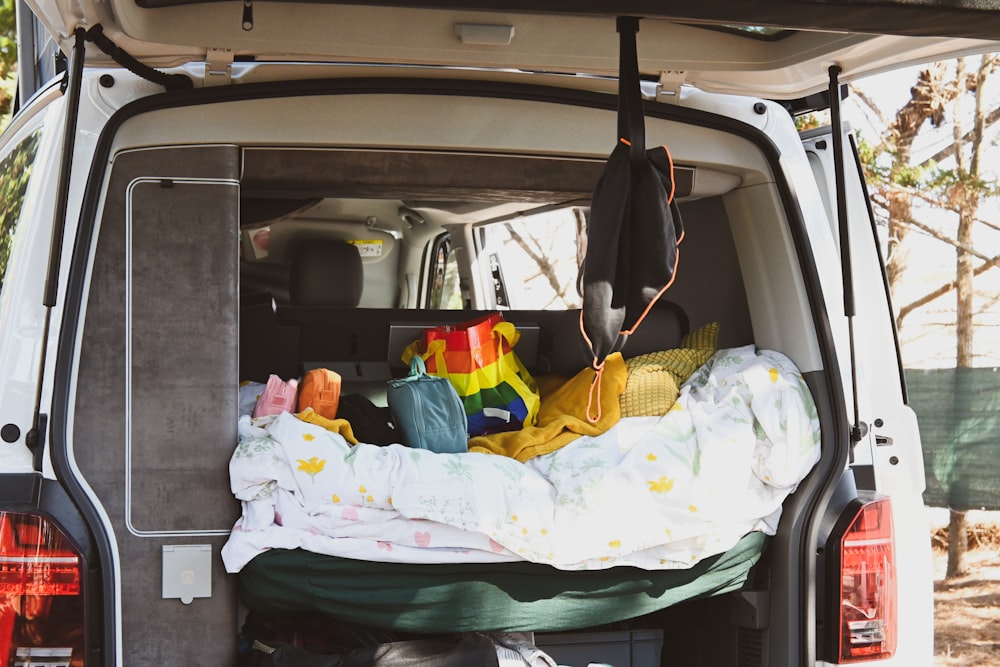 the back of a van with a bed in the back