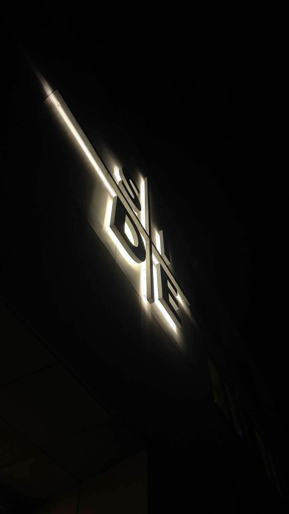 a close up of a lit up sign on the side of a building