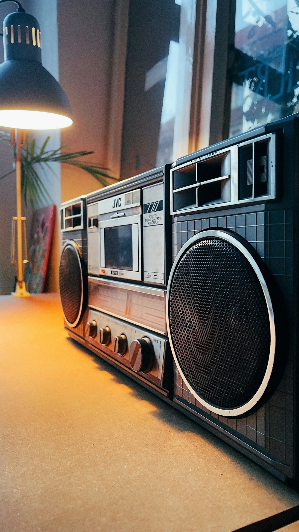 a radio sitting on top of a table next to a lamp