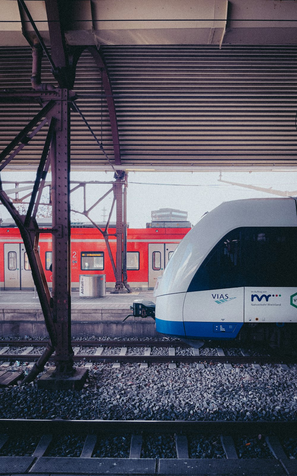 a white and blue train traveling down train tracks