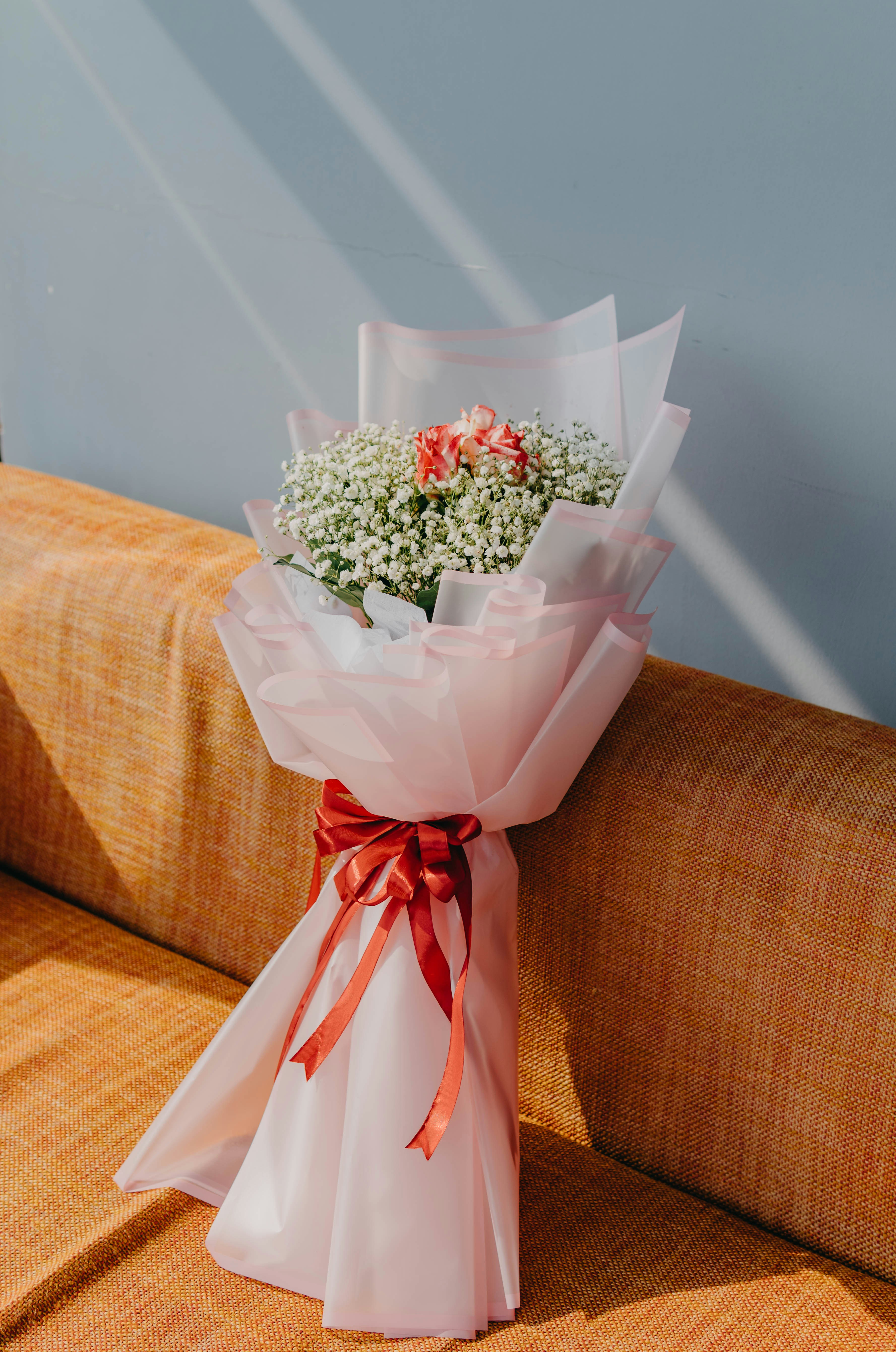 a bouquet of flowers sitting on top of a couch