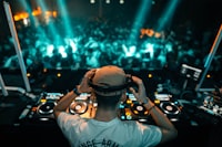 A man wearing headphones in front of a dj set