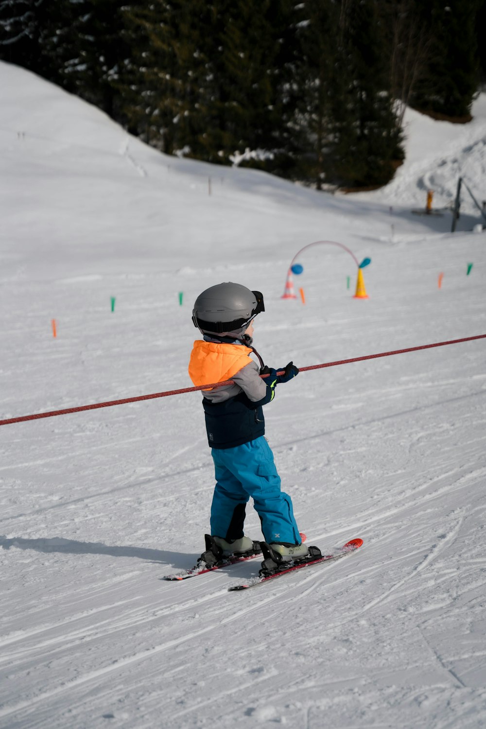 a little boy riding skis down a snow covered slope