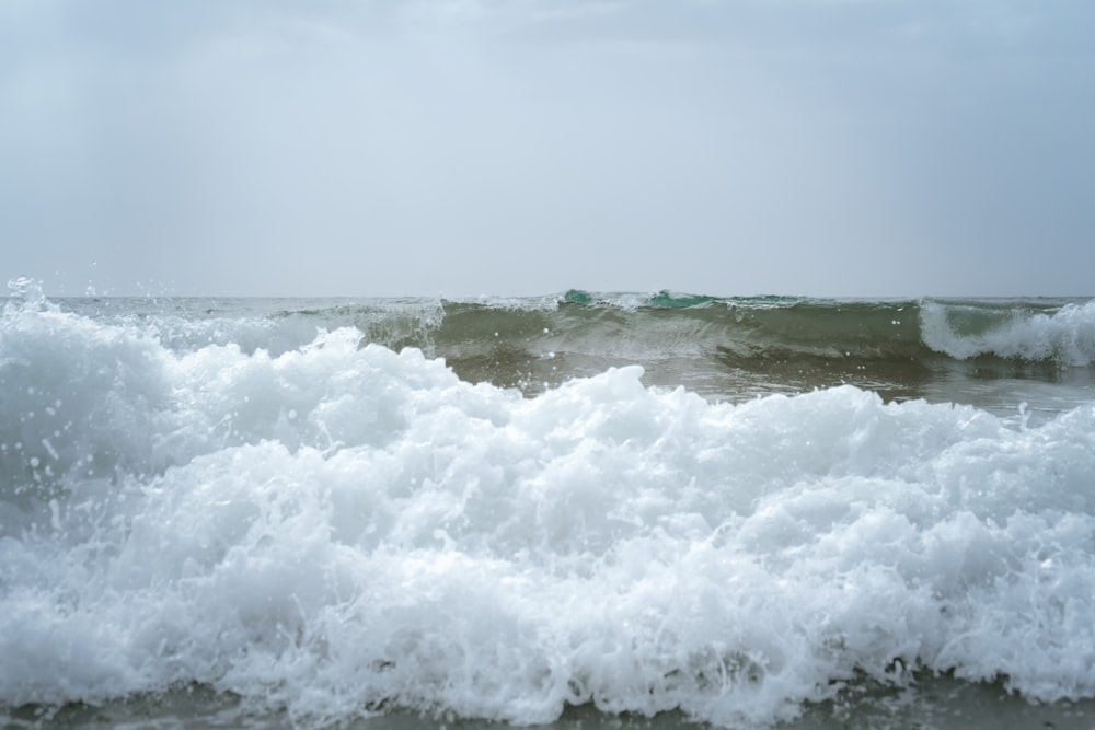 a large body of water with a wave coming in