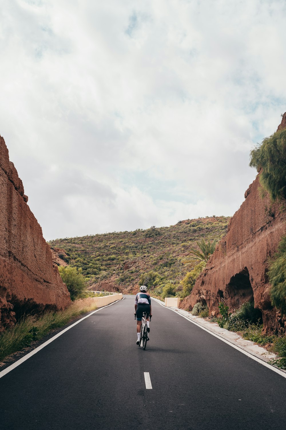 a person riding a bike down a road