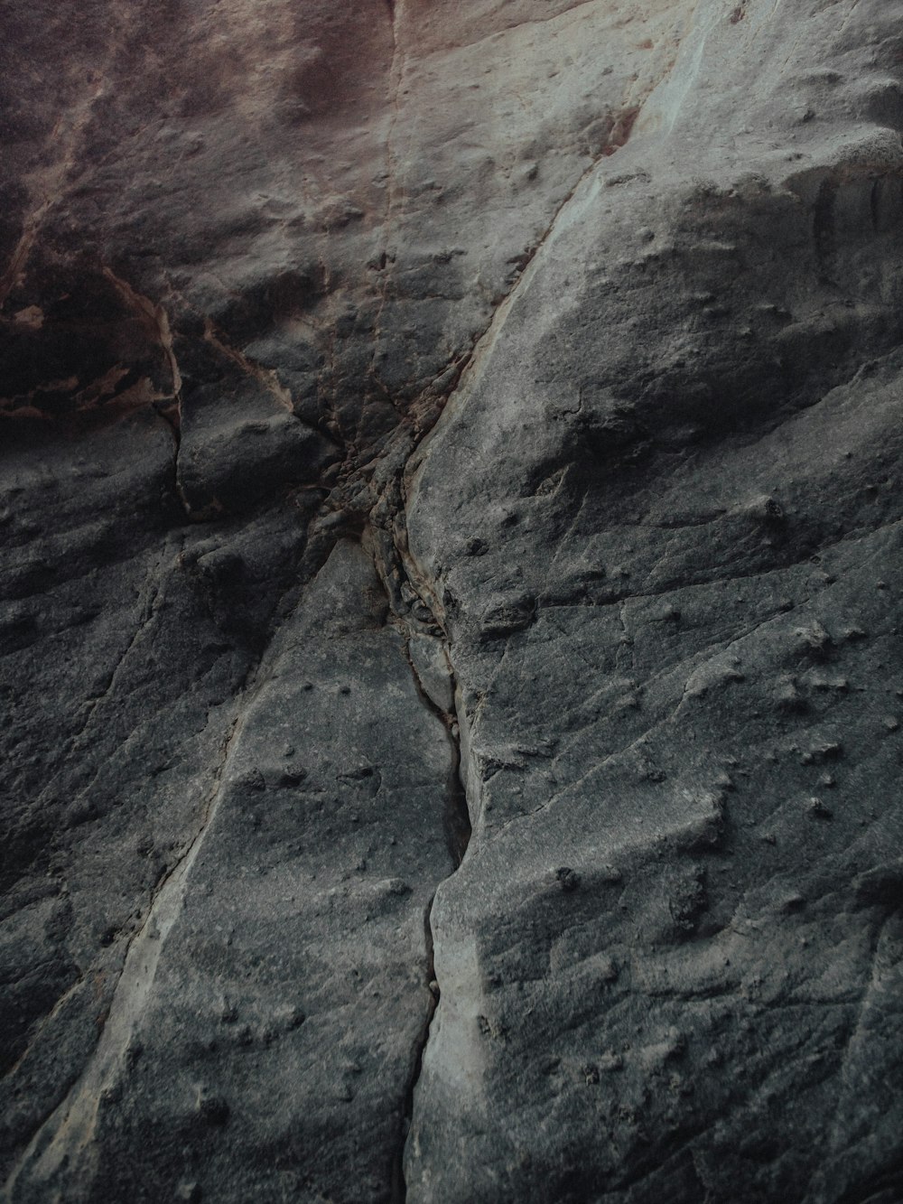 a person climbing up the side of a mountain