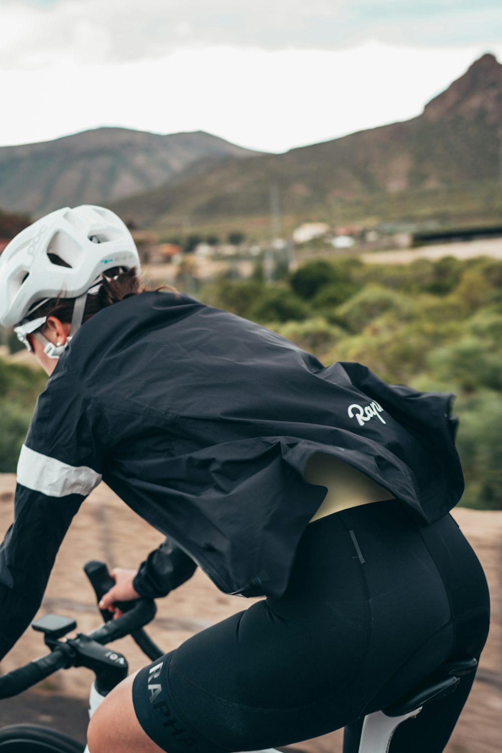 a man riding a bike down a dirt road