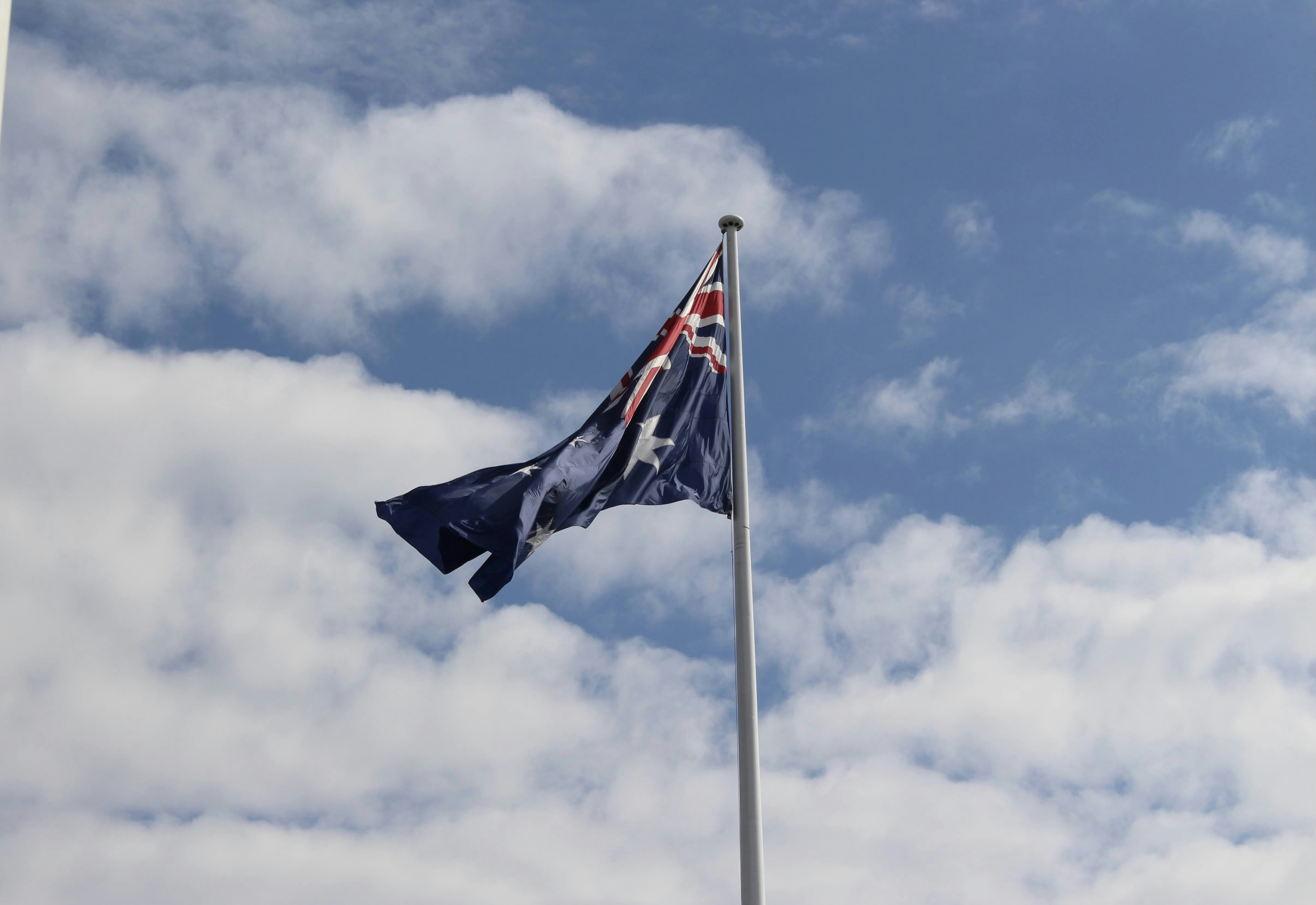 A flag flying in the wind on a cloudy day photo – Free Flag Image on ...