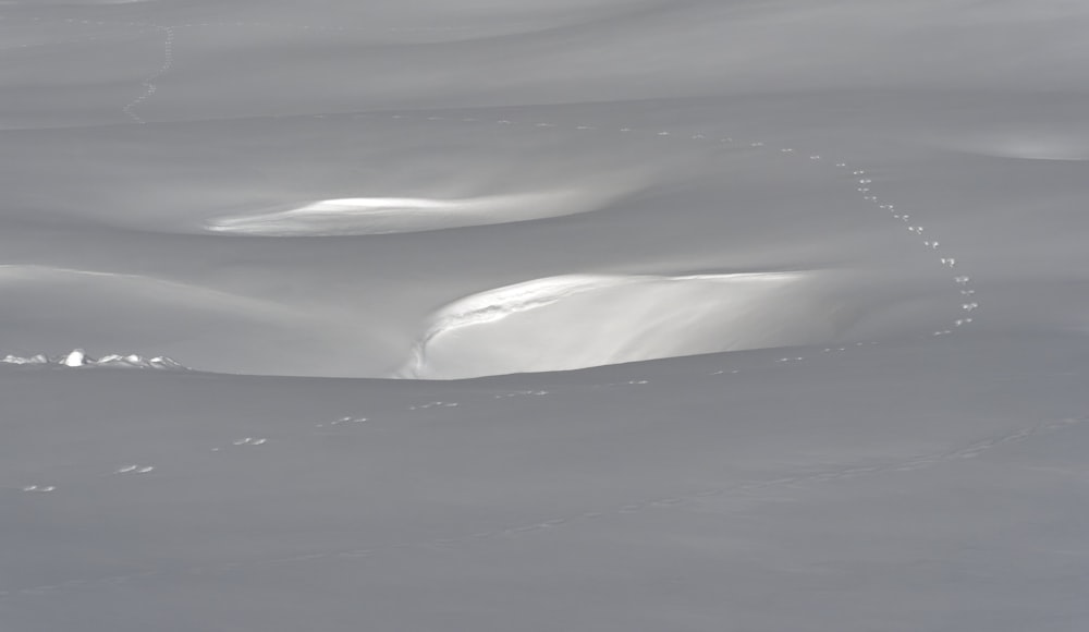 a person riding skis down a snow covered slope