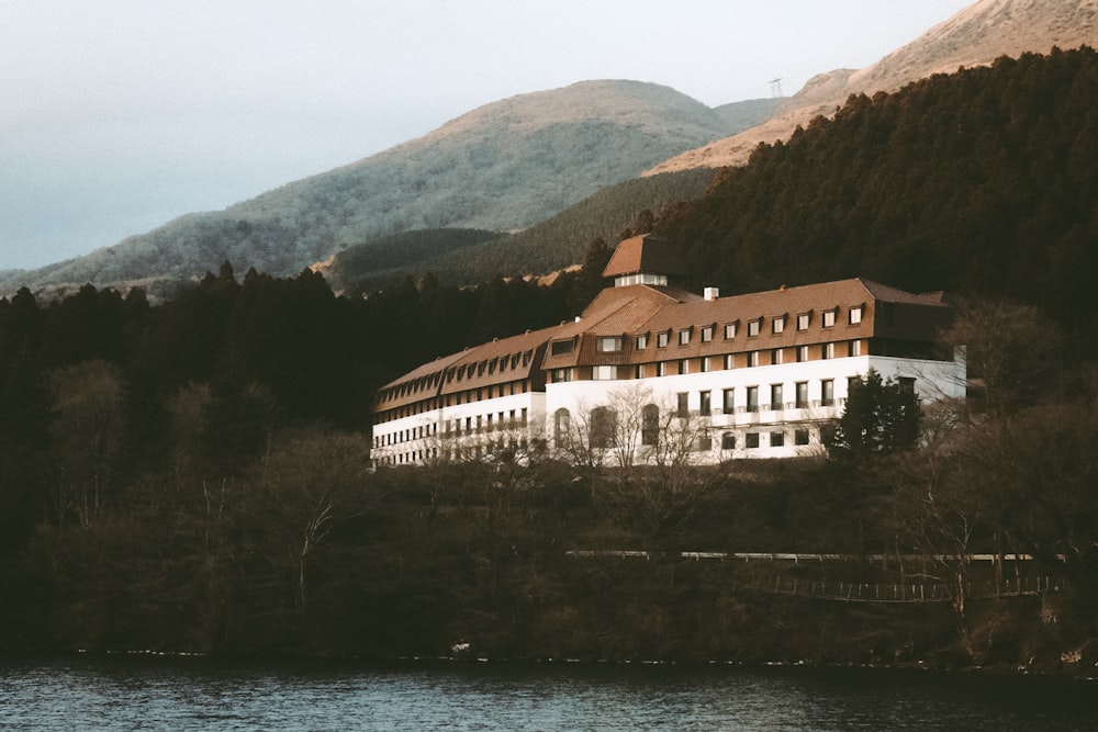 a large building sitting on top of a lush green hillside