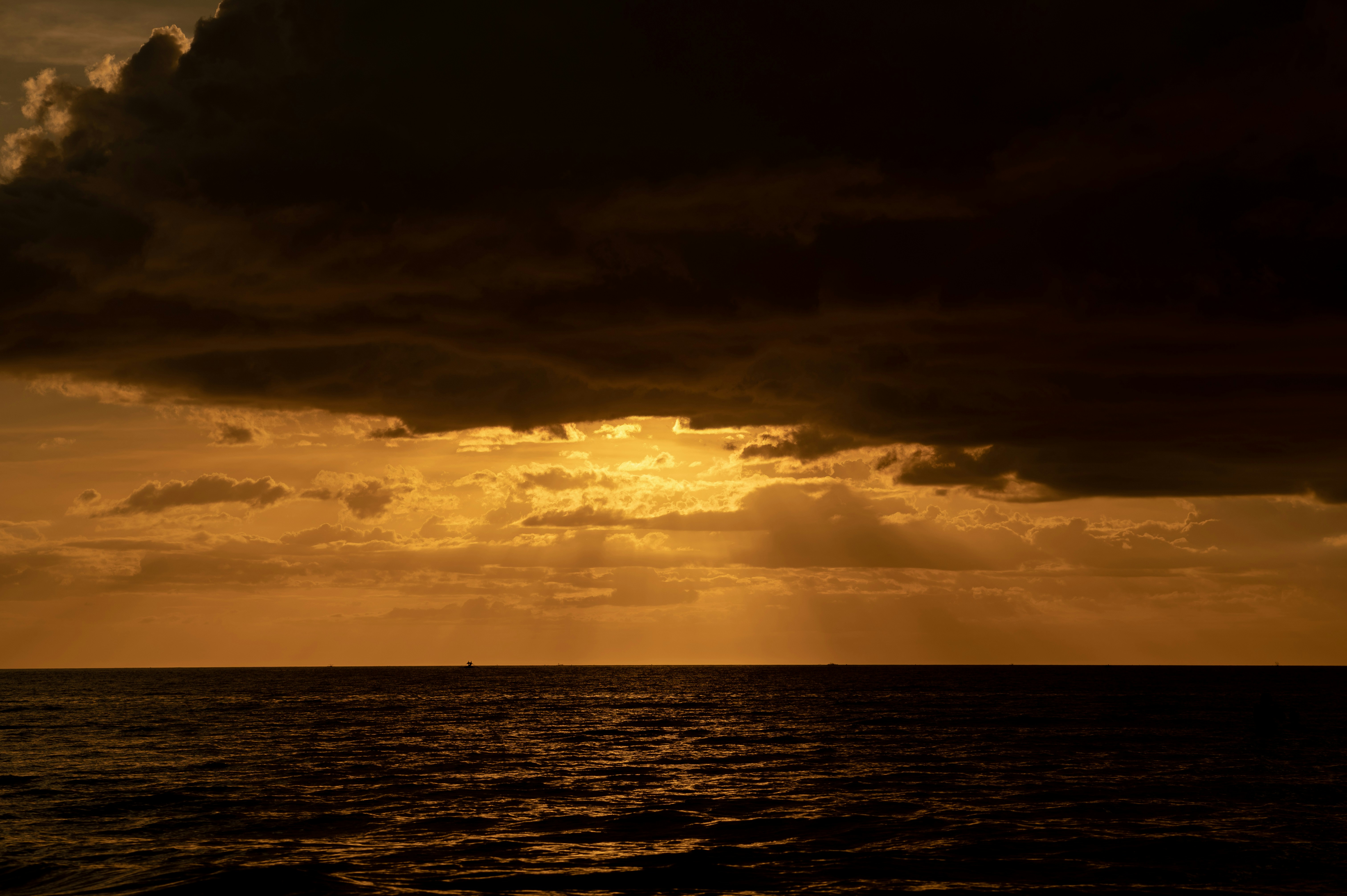 a large body of water under a cloudy sky