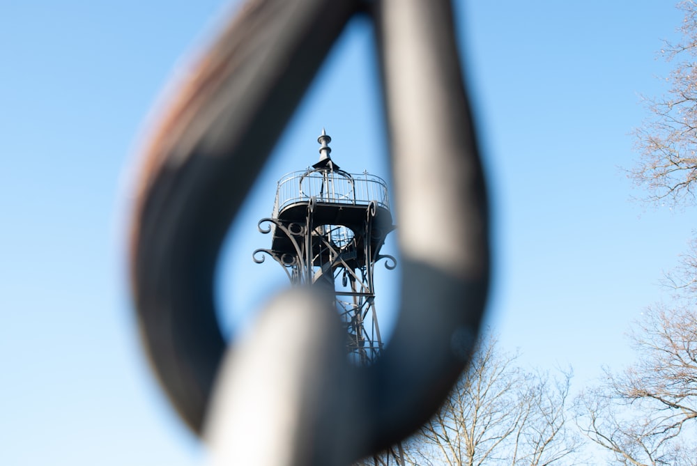 a view of a clock tower through a fence