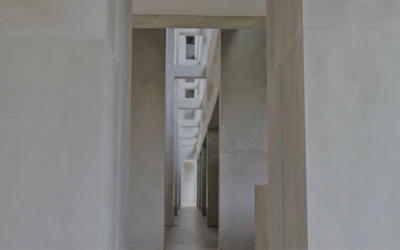 Hospital corridor with minimalist design and gentle pastel accents.