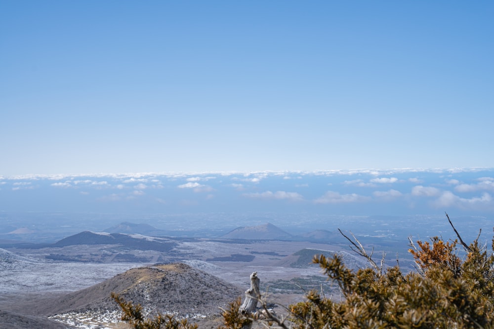 a view of a mountain range with a few clouds in the sky