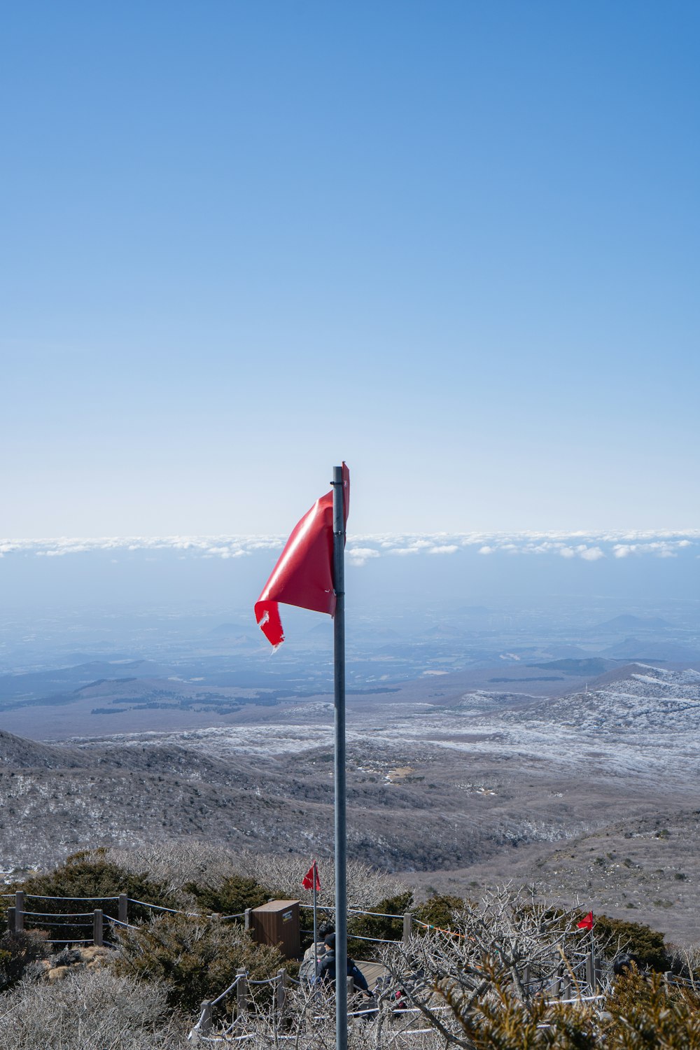 a red flag sticking out of the side of a hill