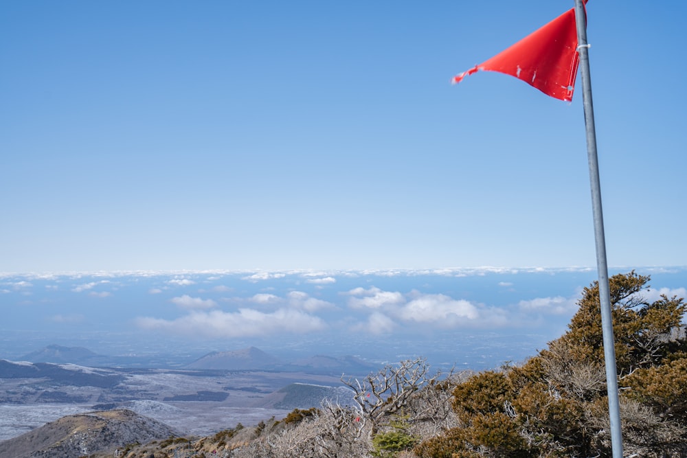 a red flag on top of a mountain
