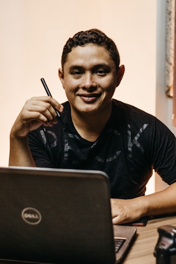 a man sitting in front of a laptop computer
