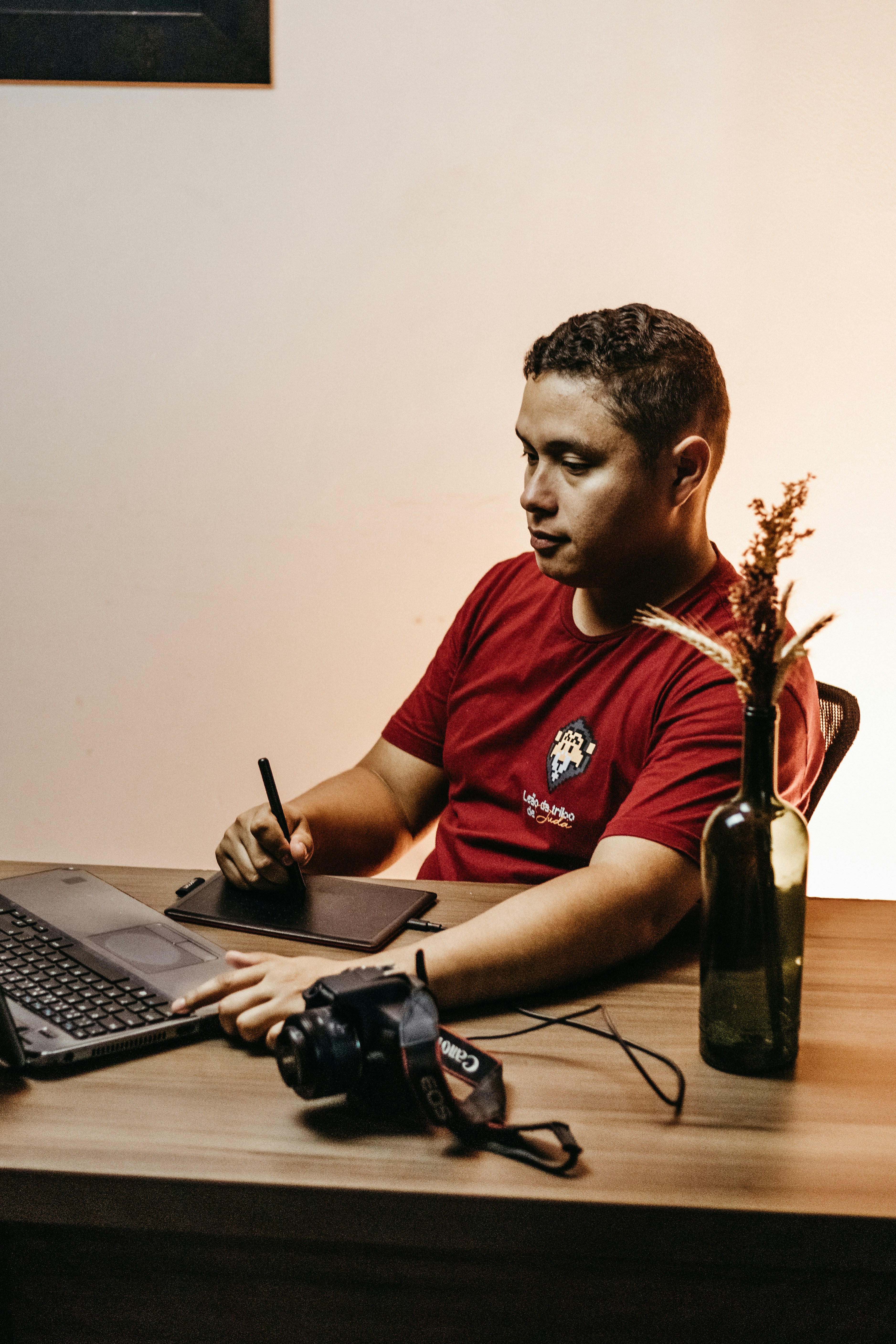 a man sitting at a desk with a laptop