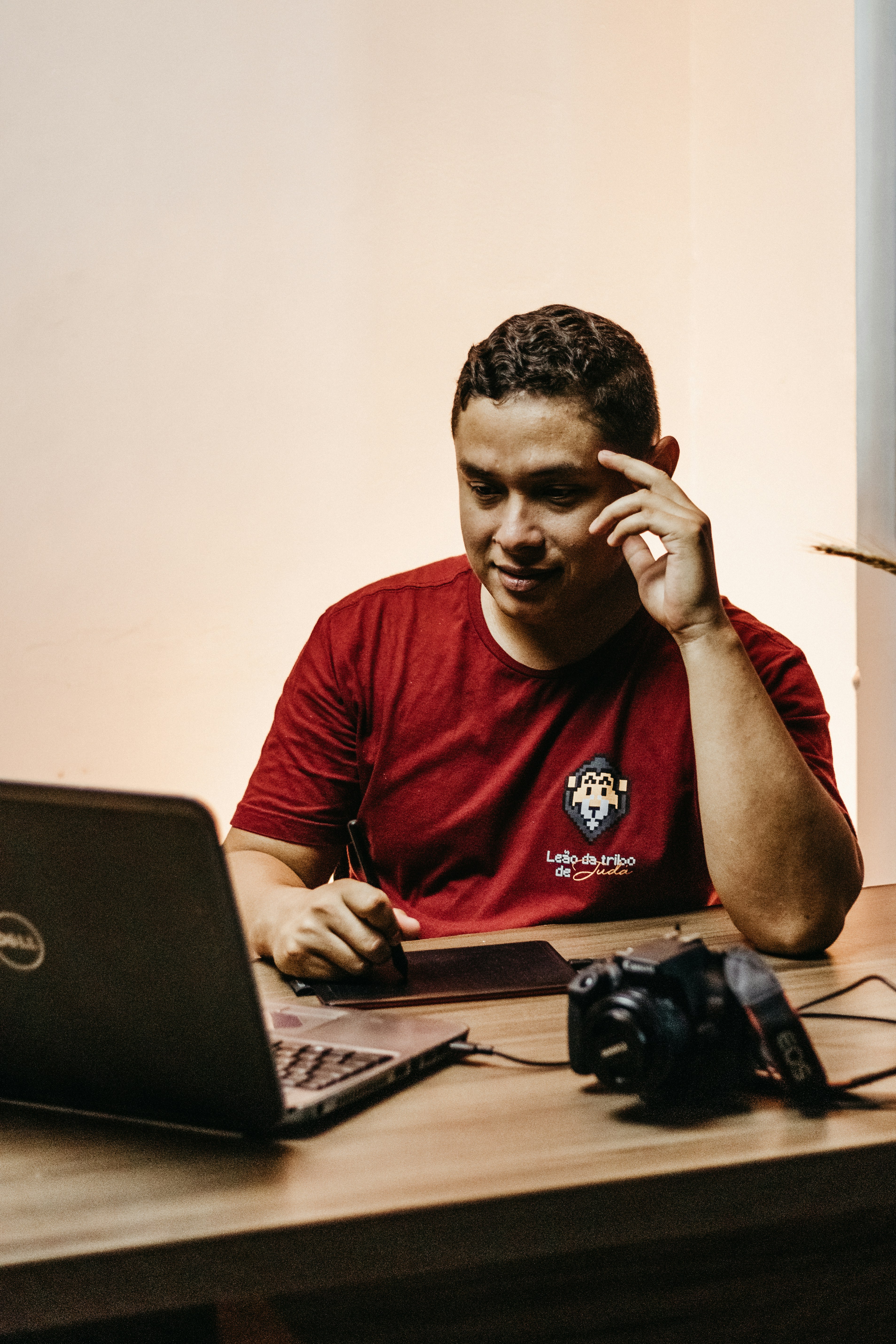 a man sitting at a table in front of a laptop computer