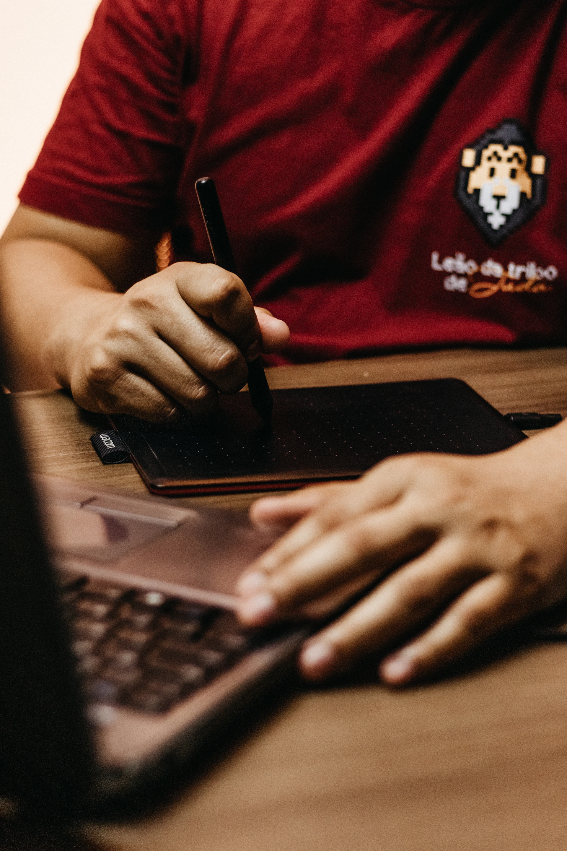 a person sitting at a table with a laptop