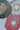 three plates with gold and pink designs on them