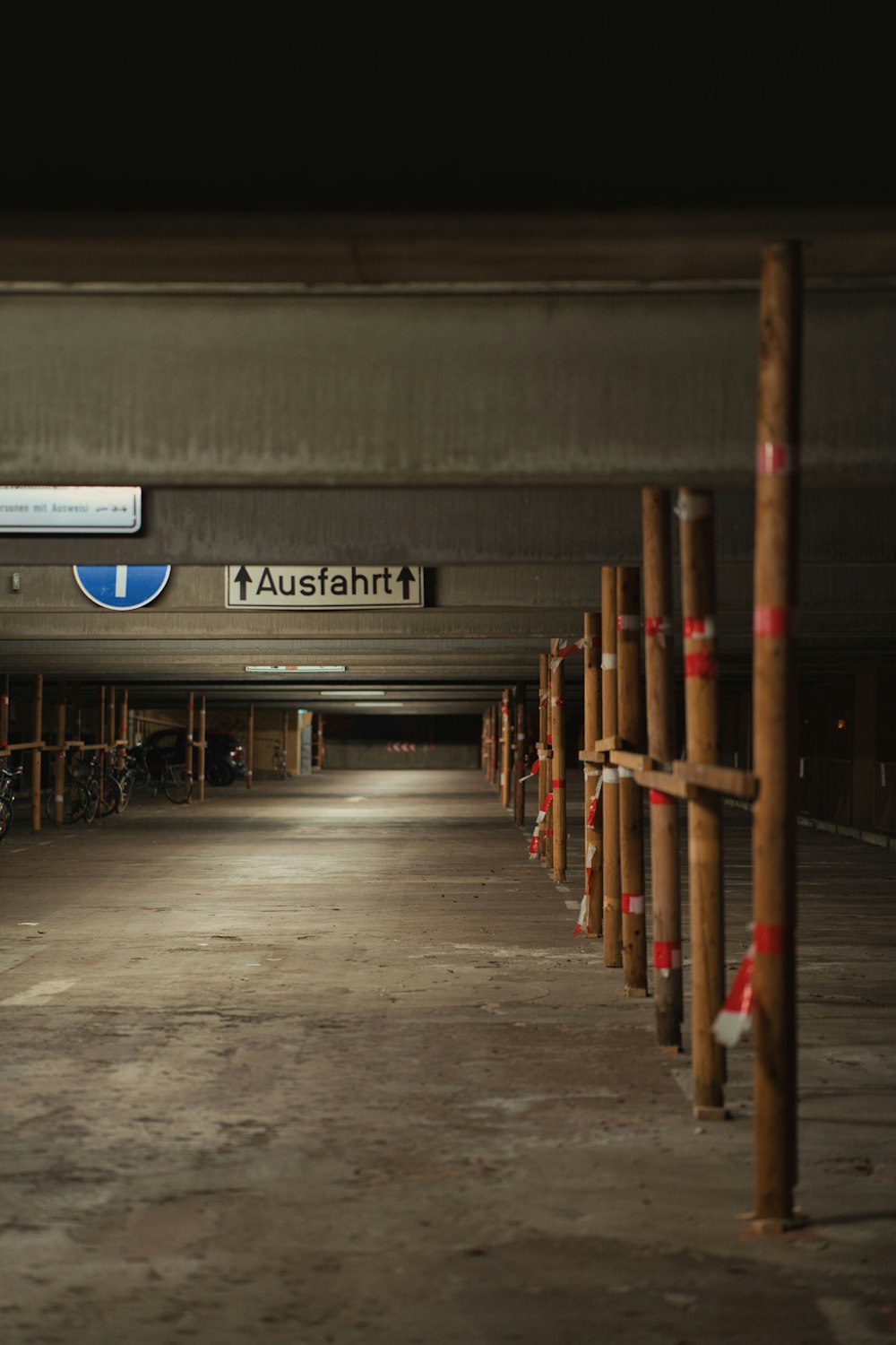 a row of wooden poles in a parking garage