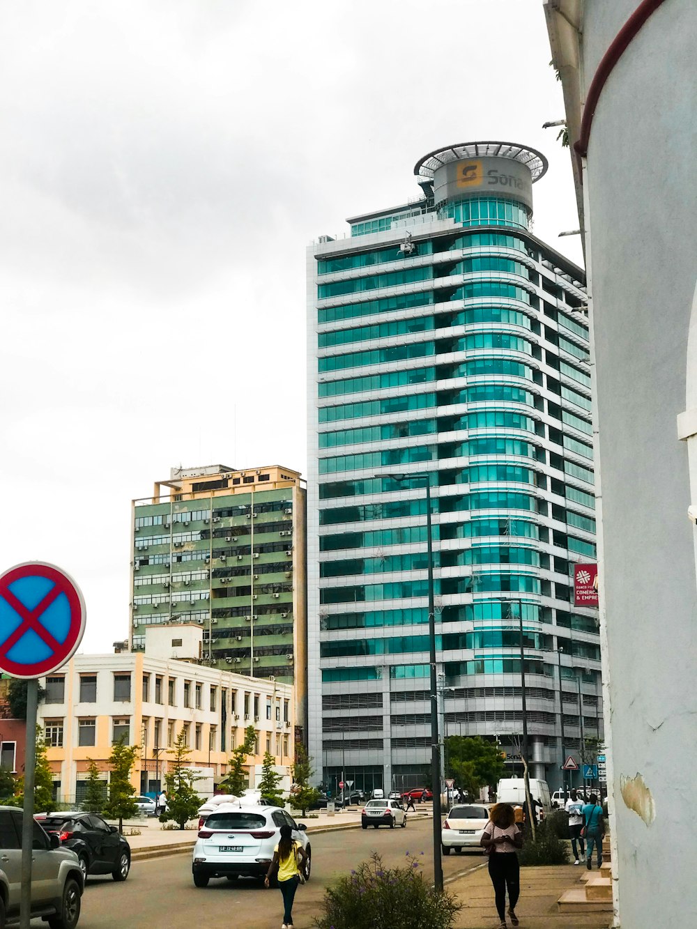 a tall blue building sitting next to a tall white building