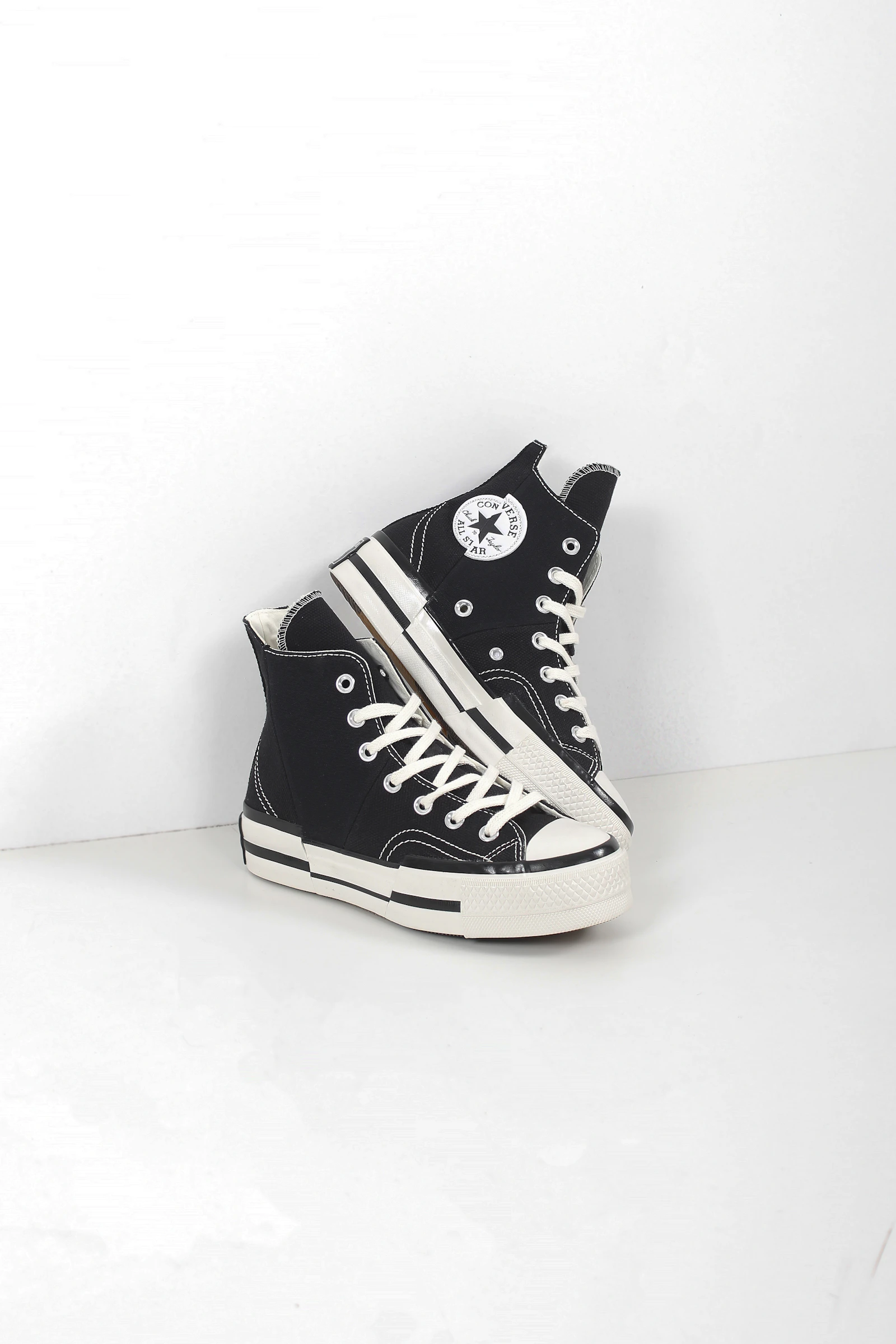 Black Converse Chuck Taylor high tops on white