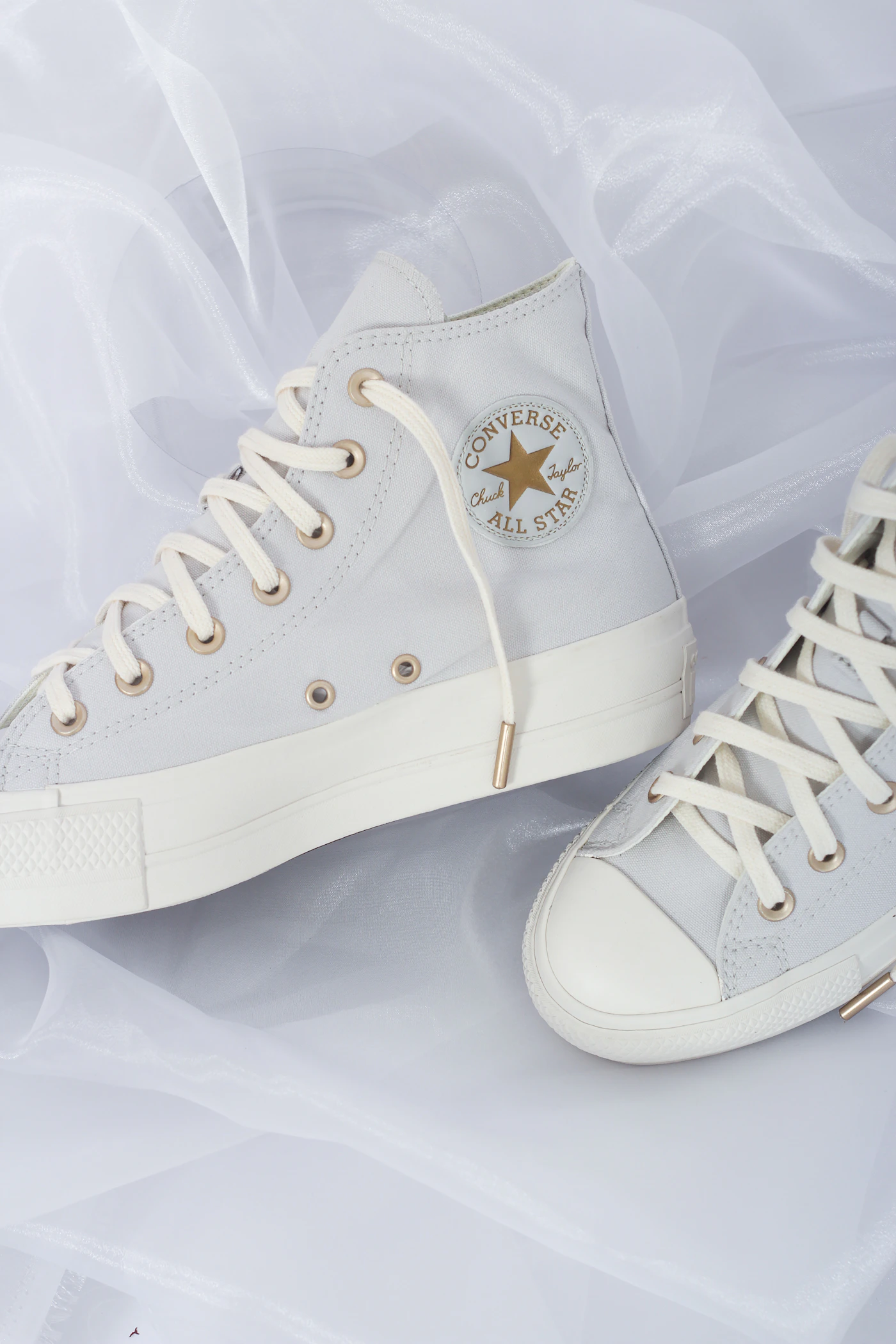 Pair of white sneakers isolated on white, ready for background cutout