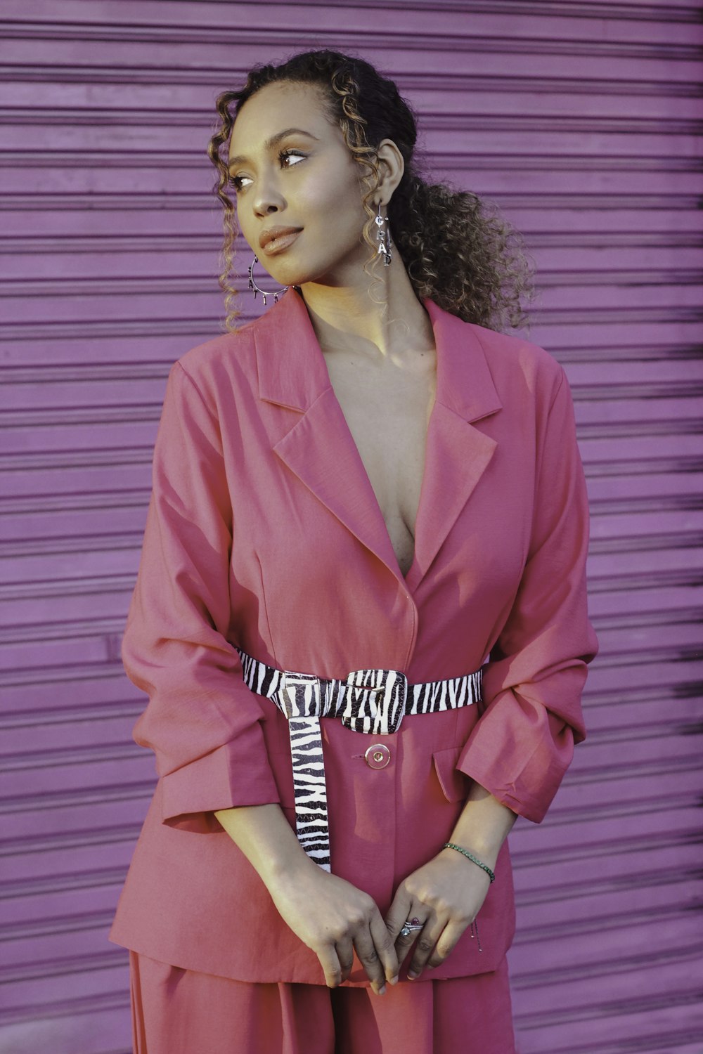 a woman standing in front of a purple wall