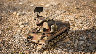 Top view of a minimalist, black 3D printed military vehicle model on a textured dark background.