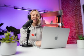 a woman sitting in front of a laptop computer