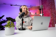 a woman sitting in front of a laptop computer