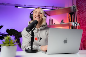 a woman sitting in front of a laptop computer