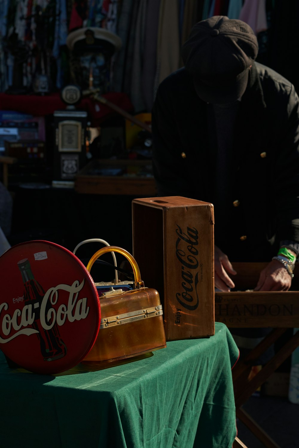 a man standing next to a table with a coca cola sign on it