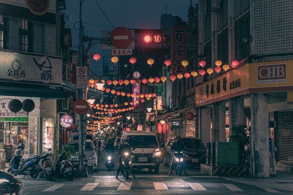 a city street filled with lots of traffic at night