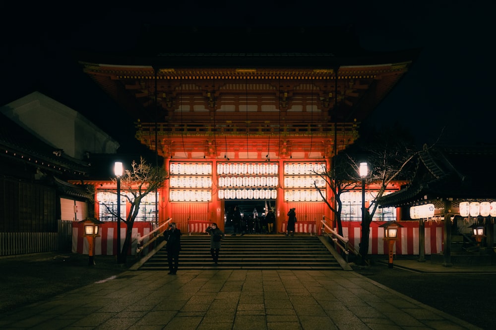 a person standing in front of a building at night