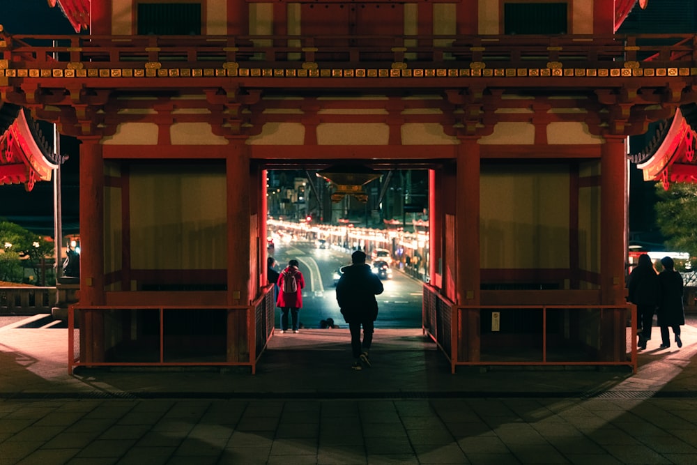 a couple of people that are standing in front of a building