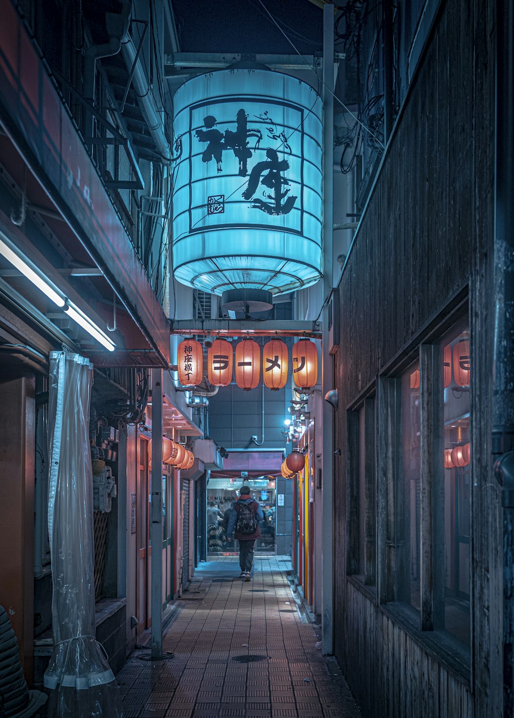 a person walking down a narrow alley way