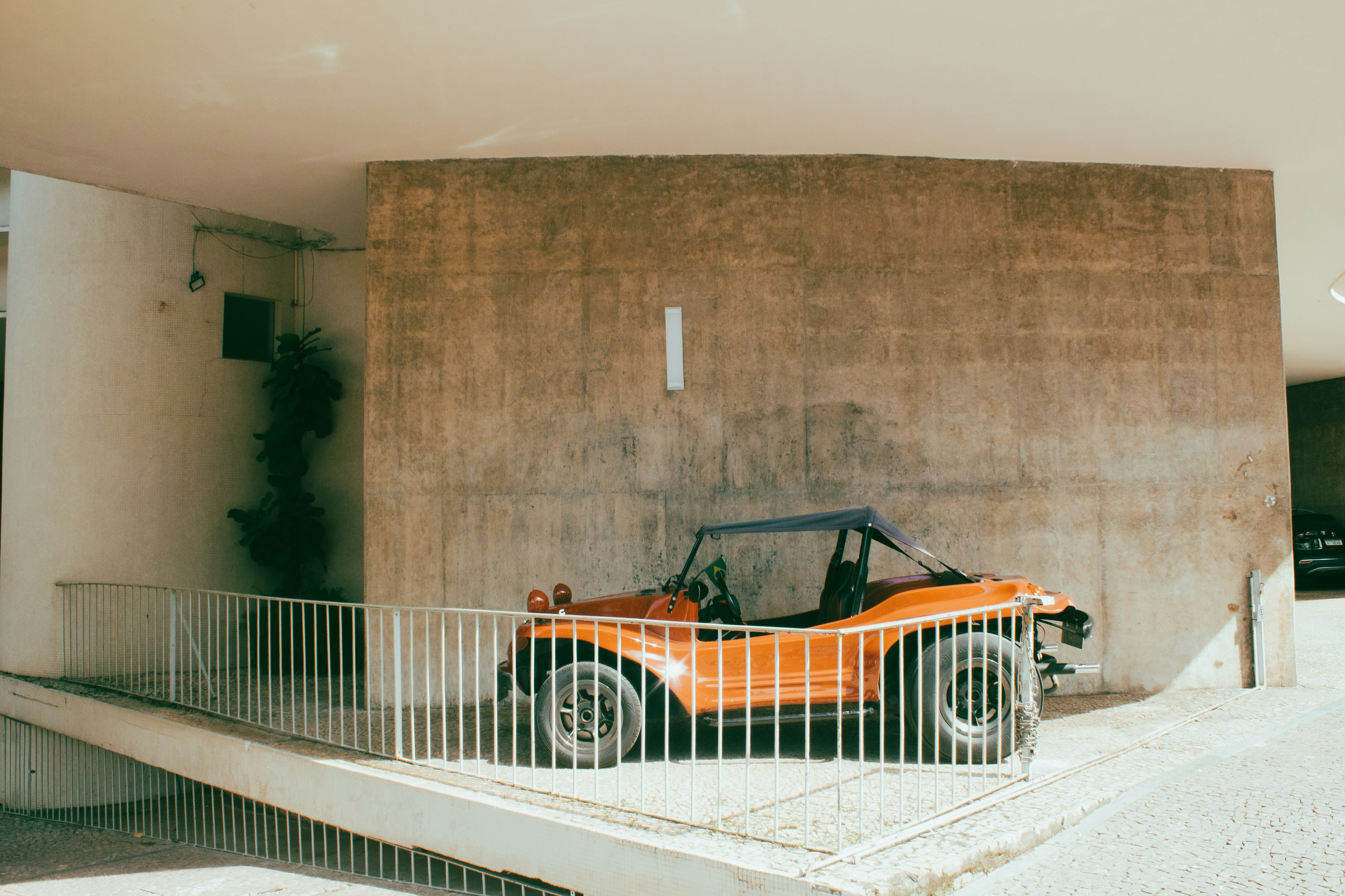 an orange car parked in front of a building