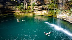 a couple of people riding water skis on a body of water