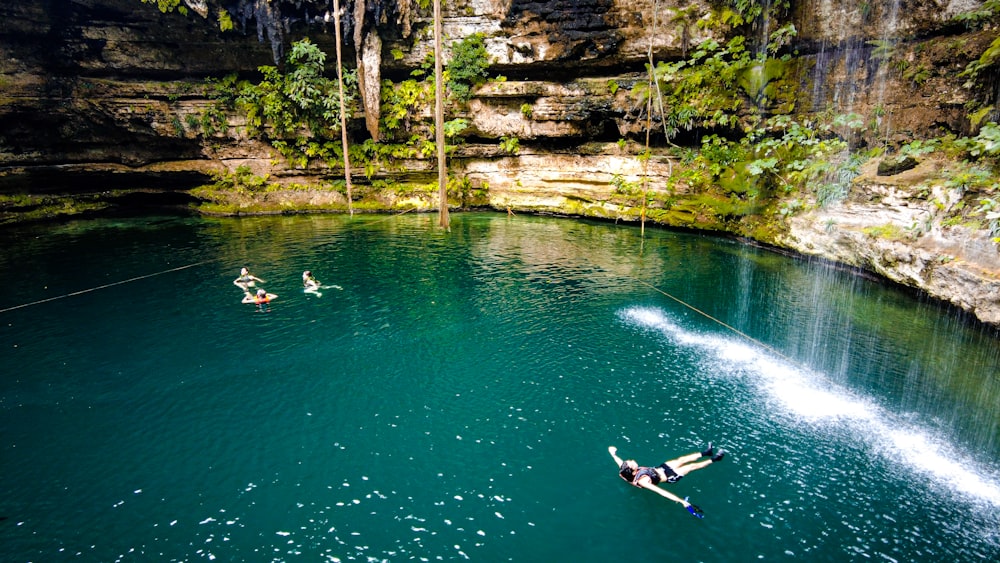 a couple of people riding water skis on a body of water