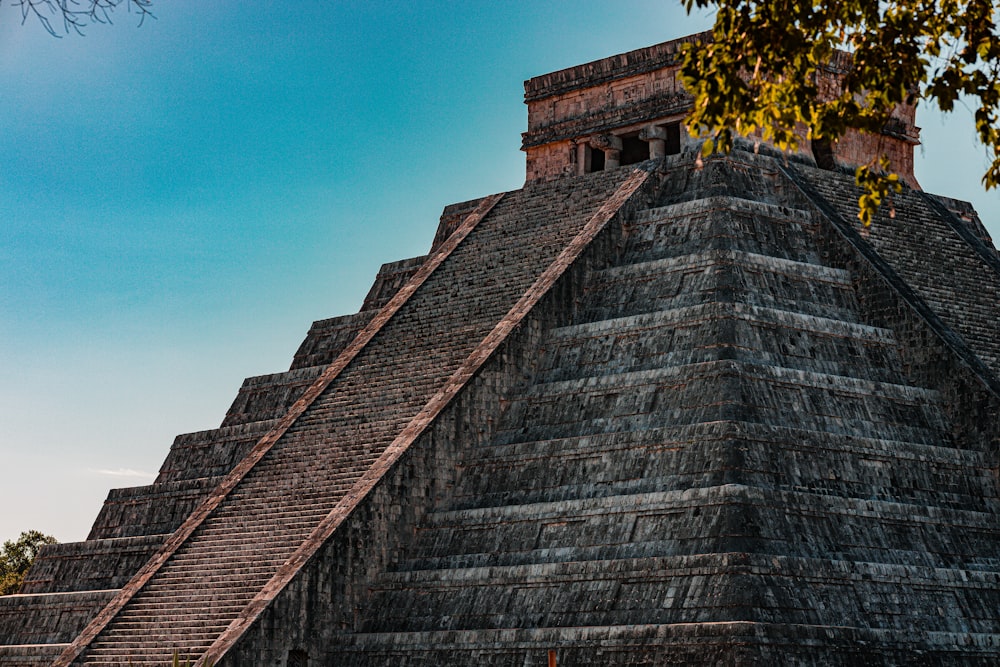 a large pyramid with a clock on top of it