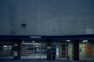 a parking garage with the door open at night