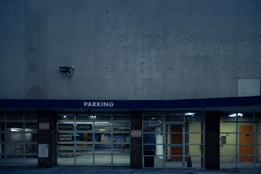 a parking garage with the door open at night