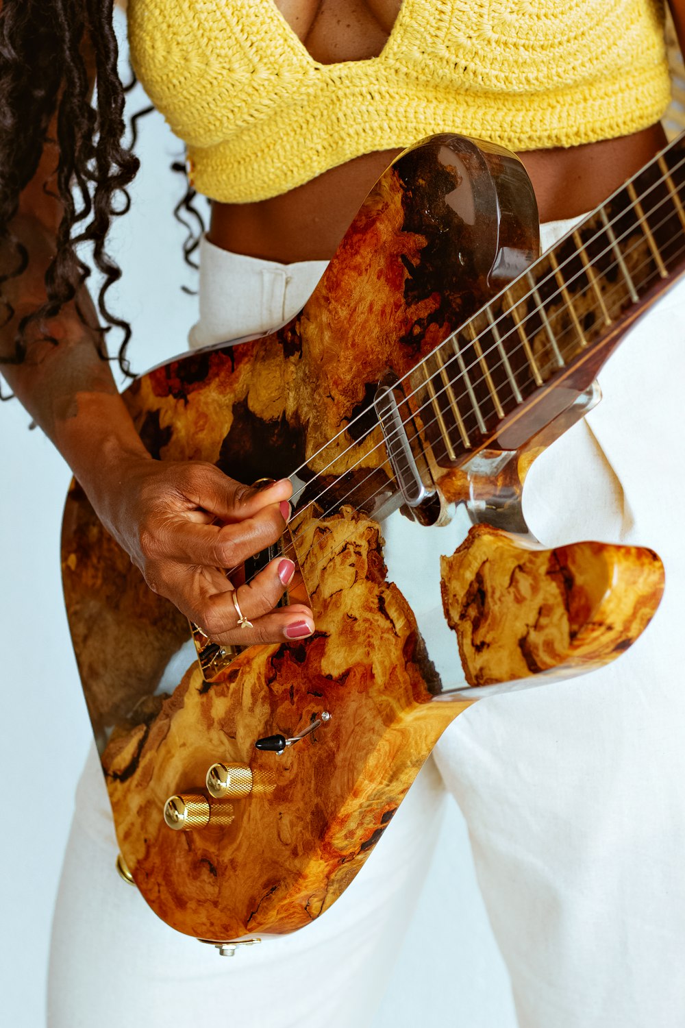 a woman holding a guitar in her hands
