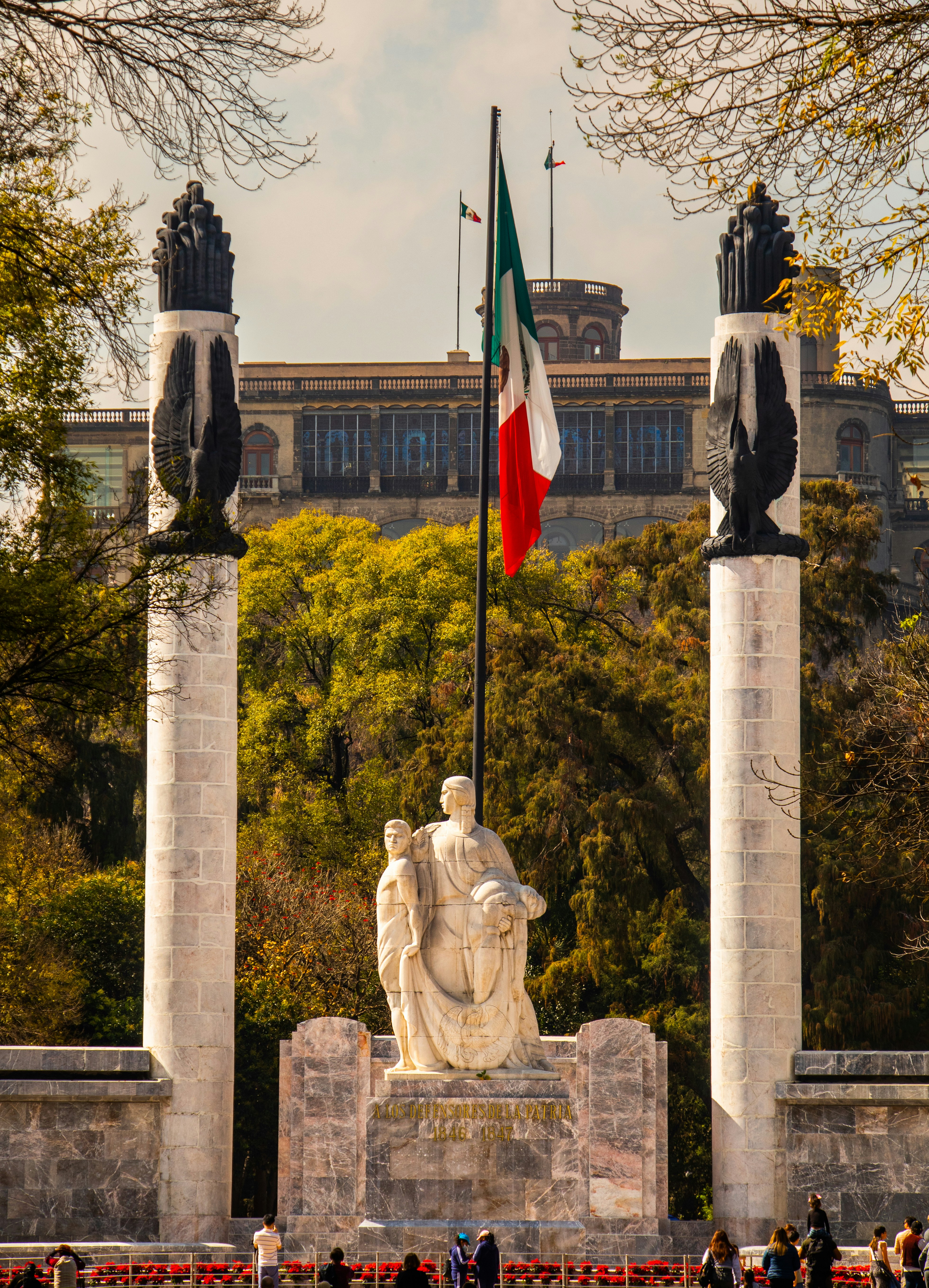 a statue with a flag on top of it